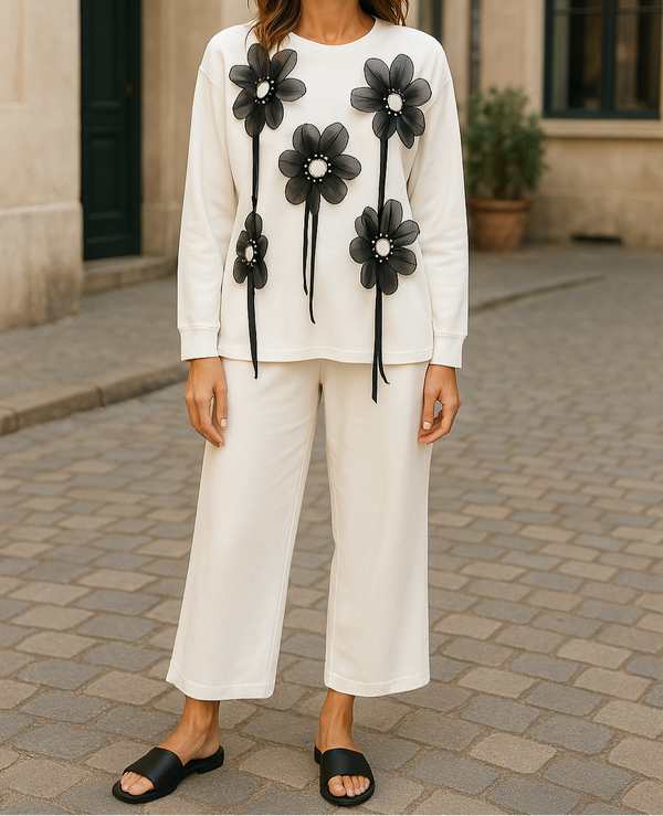 Cream lounge set with wide-leg pants and oversized top featuring large black 3D floral appliqués – stylish and comfy for casual wear