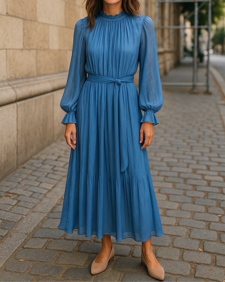 Modest long-sleeve blue maxi dress with pleated texture, waist tie, and ruffled cuffs – elegant and lightweight for hijabi women