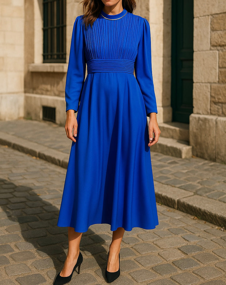 Modest cobalt blue pleated midi dress with long sleeves and a high neckline, perfect for hijabi women