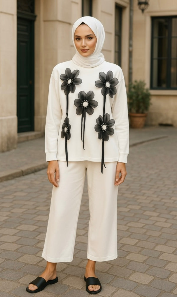 Cream lounge set with wide-leg pants and oversized top featuring large black 3D floral appliqués – stylish and comfy for casual wear